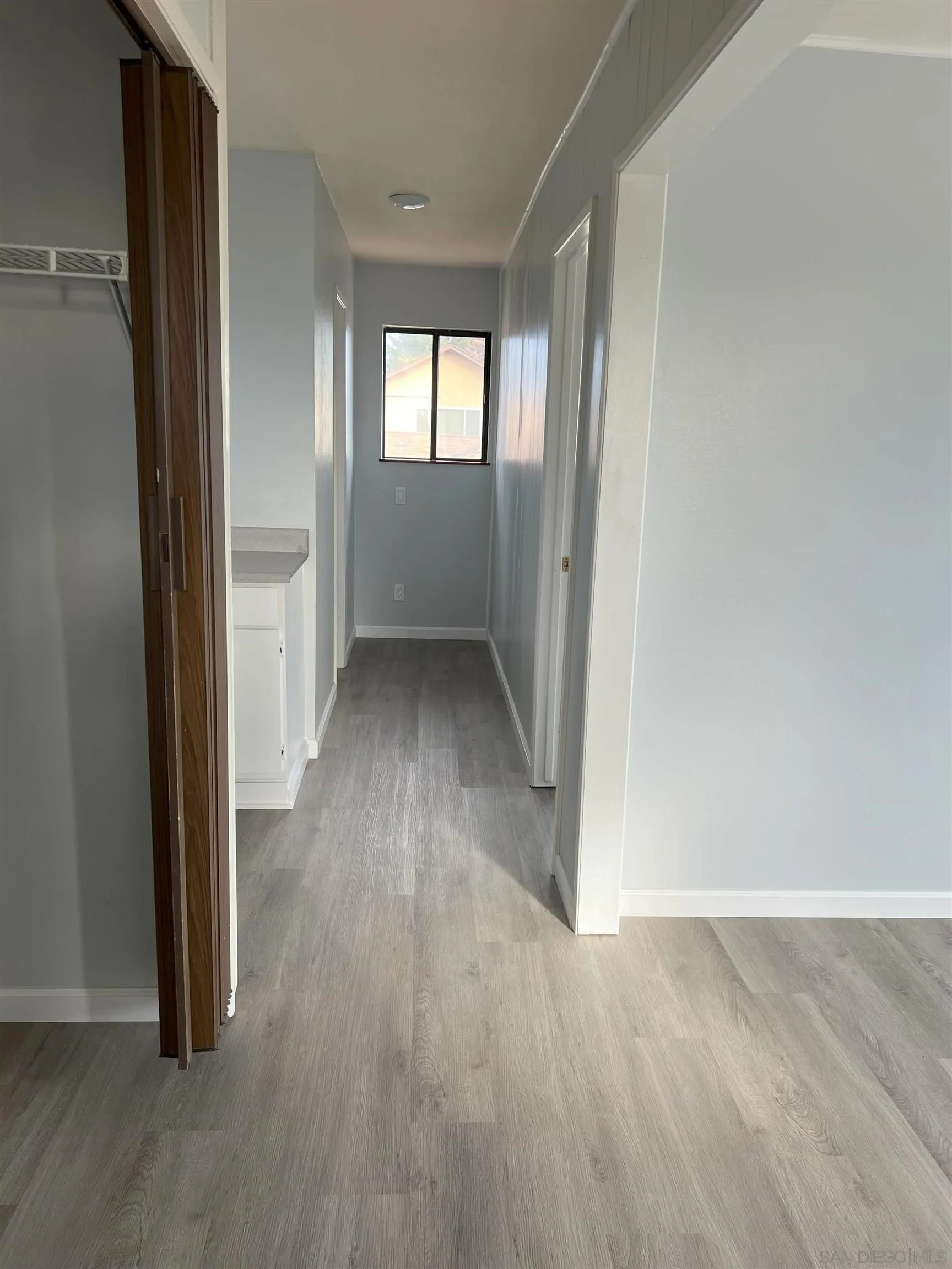 4054 Mt Barnard Avenue San Diego, CA 92111 - Photo 37 of 55 an empty room with wooden floor and windows