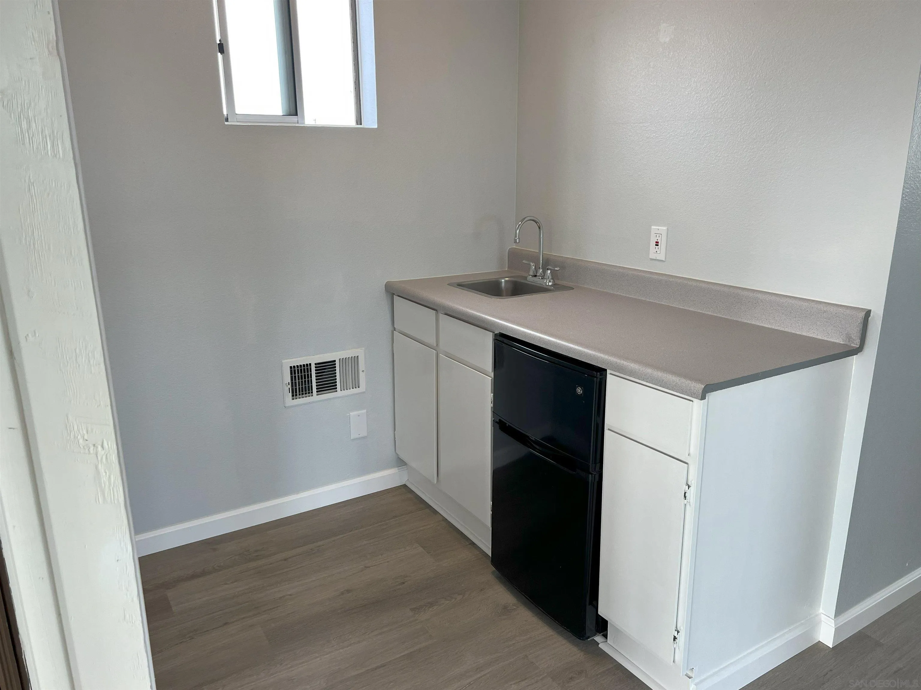 4054 Mt Barnard Avenue San Diego, CA 92111 - Photo 40 of 55 a kitchen with a sink cabinets and a window
