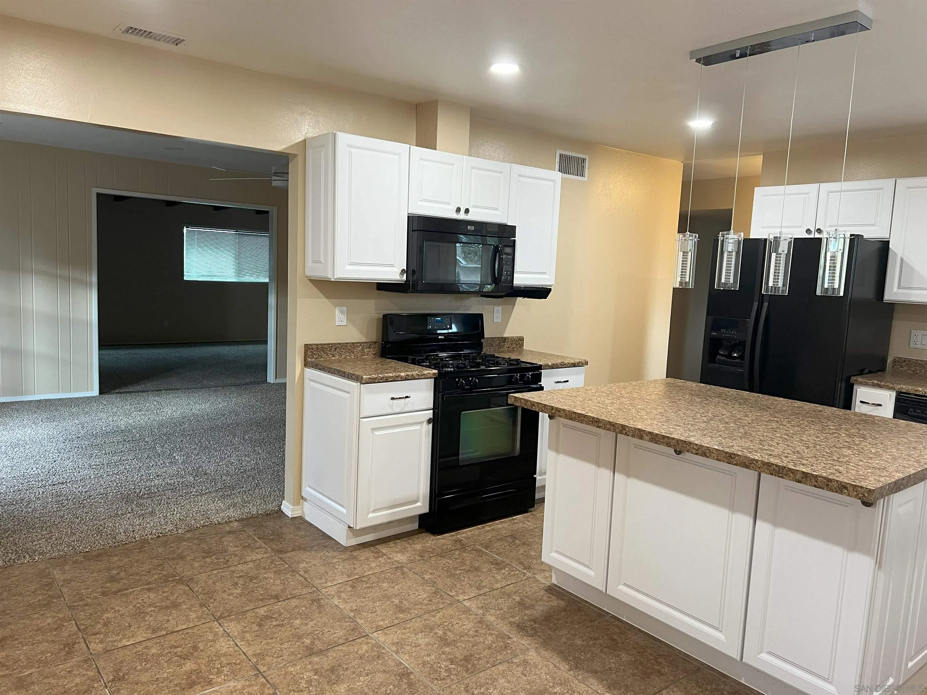 4054 Mt Barnard Avenue San Diego, CA 92111 - Photo 4 of 55 a kitchen with stainless steel appliances granite countertop a stove a sink and a refrigerator