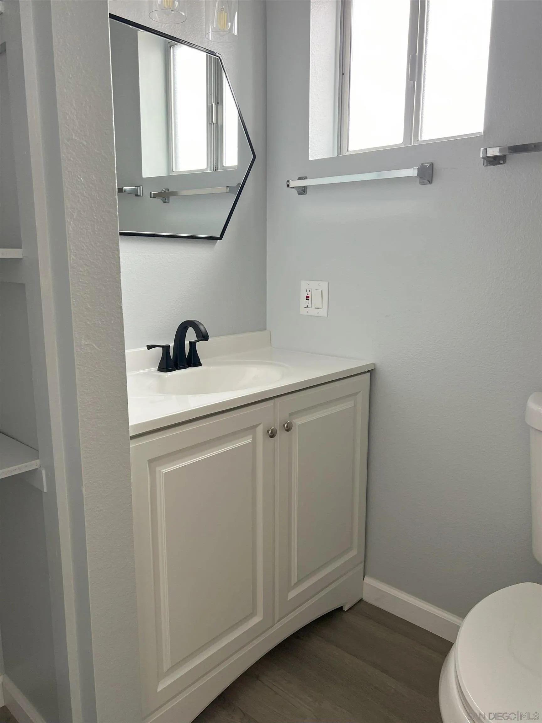 4054 Mt Barnard Avenue San Diego, CA 92111 - Photo 44 of 55 a bathroom with a sink a toilet and mirror