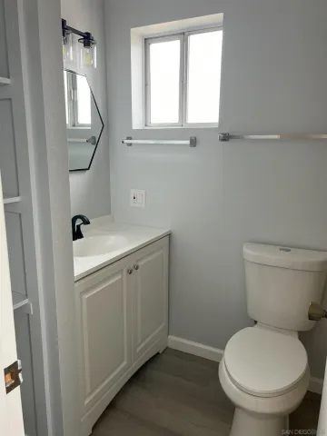 an empty room with wooden floor and closet