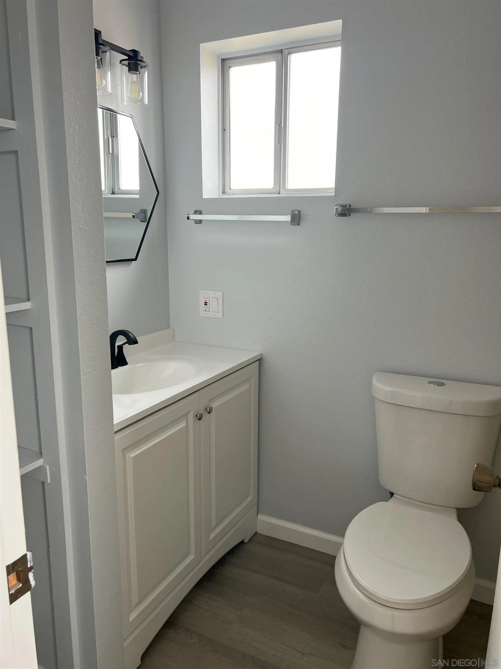 4054 Mt Barnard Avenue San Diego, CA 92111 - Photo 46 of 55 a bathroom with a toilet sink and mirror