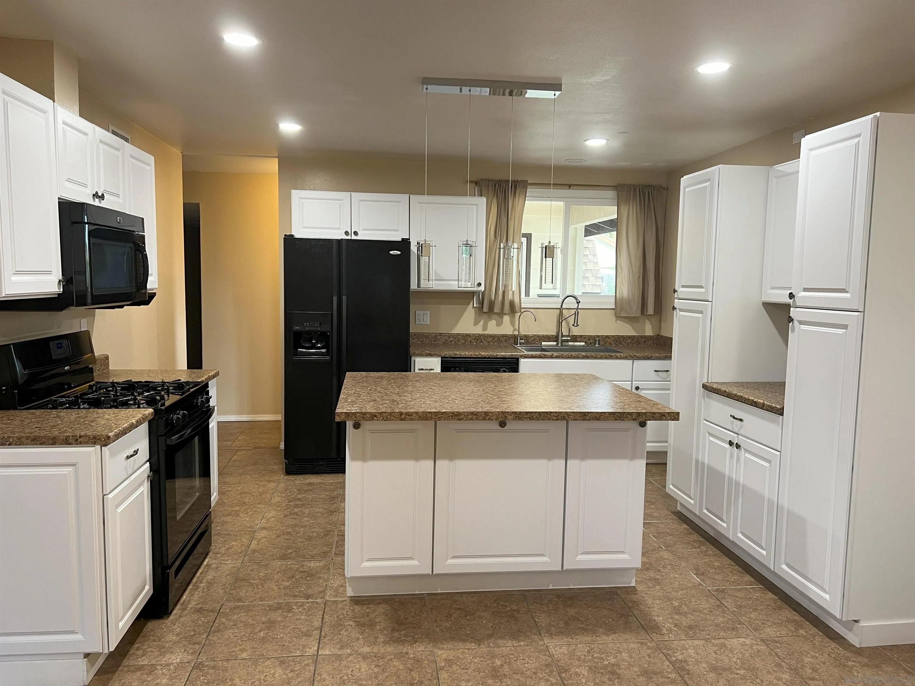 4054 Mt Barnard Avenue San Diego, CA 92111 - Photo 6 of 55 a kitchen with stainless steel appliances a refrigerator stove and sink