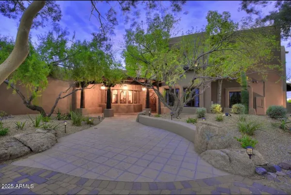 a view of a house with backyard and a garden