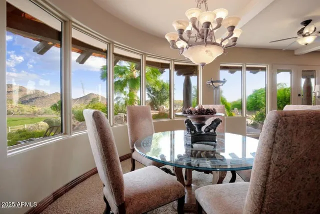 a view of a dining room with furniture and chandelier