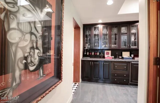 a kitchen with kitchen island granite countertop a sink cabinets and stainless steel appliances