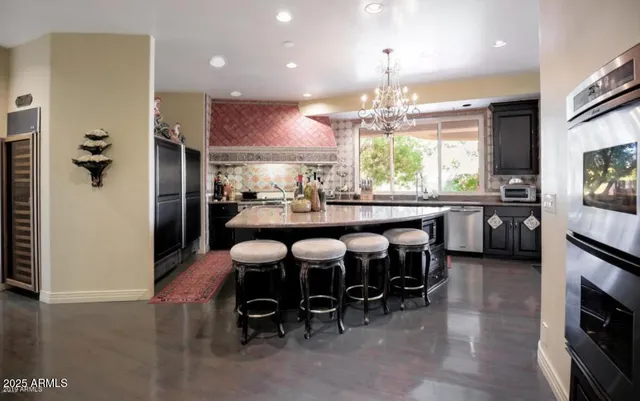 a kitchen with stainless steel appliances granite countertop a sink and stove