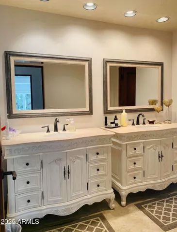 a bathroom with a granite countertop sink vanity and mirror
