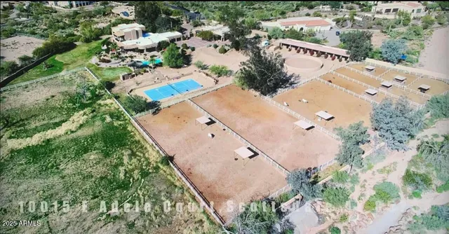 a view of a house with a yard and potted plants