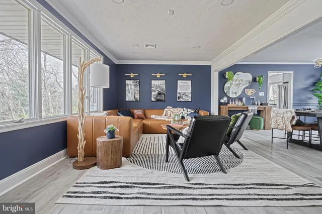 a living room with a flat screen tv with wooden floor
