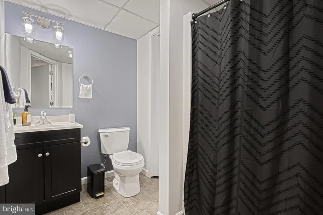 a view of a house with a yard and potted plants