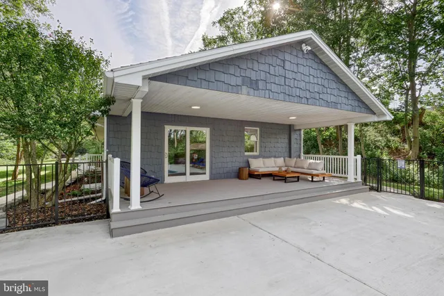 a view of an outdoor sitting area with wooden walls