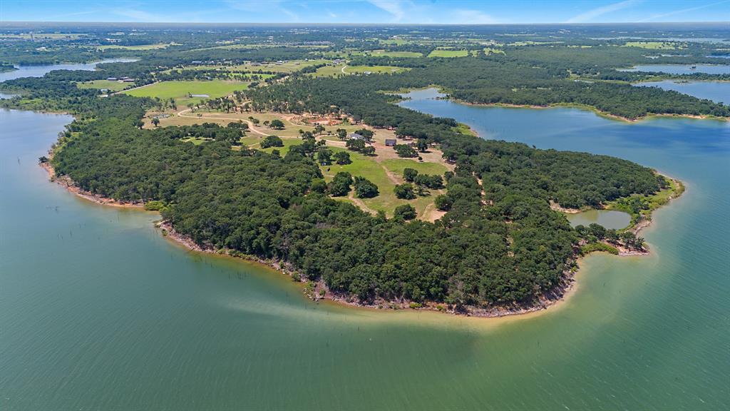 23507 Alexander Road Pilot Point, TX 76258 - Photo 21 of 26 Drone / aerial view of a forest and a nearby body of water
