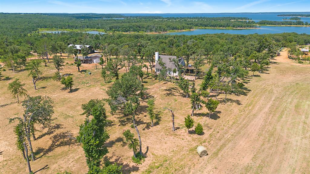 23507 Alexander Road Pilot Point, TX 76258 - Photo 7 of 26 Aerial view of a nearby body of water and a heavily wooded area