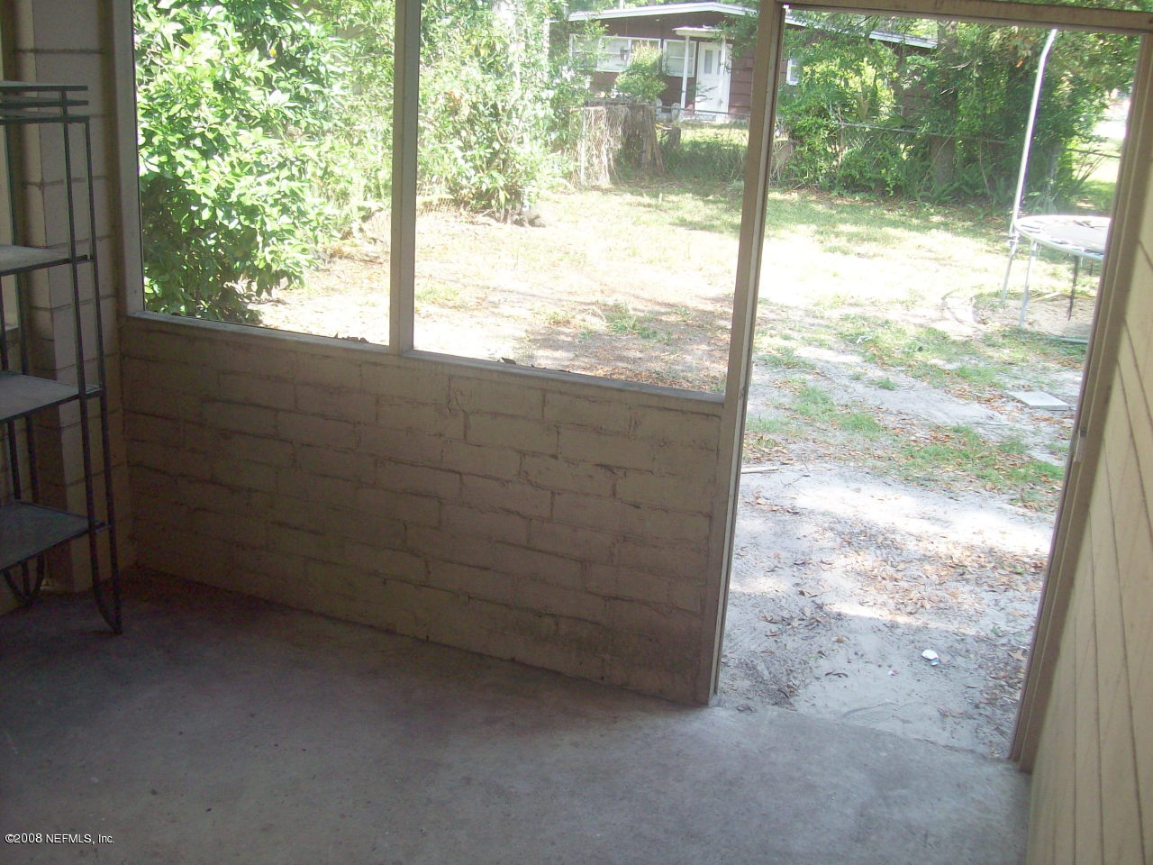 7033 May Apple Road Jacksonville, FL 32211 - Photo 16 of 19 screened patio leading to back yard
