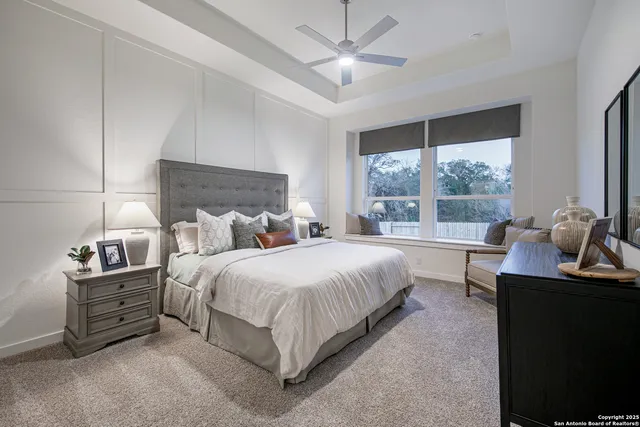 a bedroom with bed and a large window