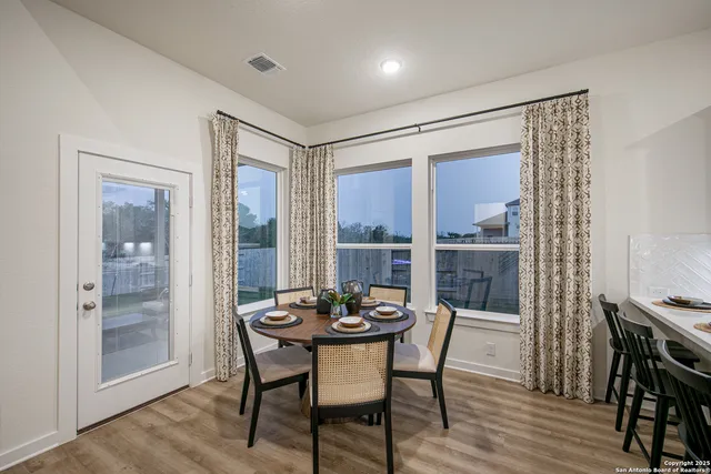 a view of a dining room with furniture window and wooden floor