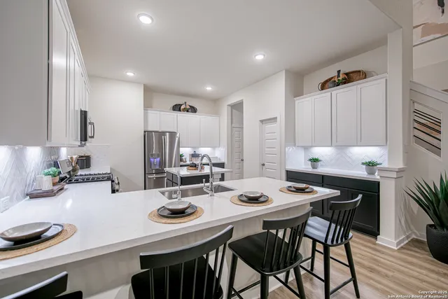 a kitchen with a dining table and chairs