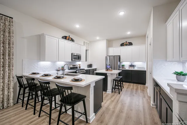 a kitchen with a table and chairs in it