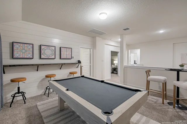 a room with furniture pool table and chair