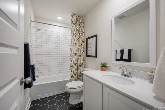 a bathroom with a sink toilet tub and shower