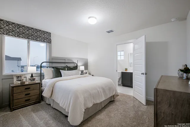 a bedroom with a bed and a dresser