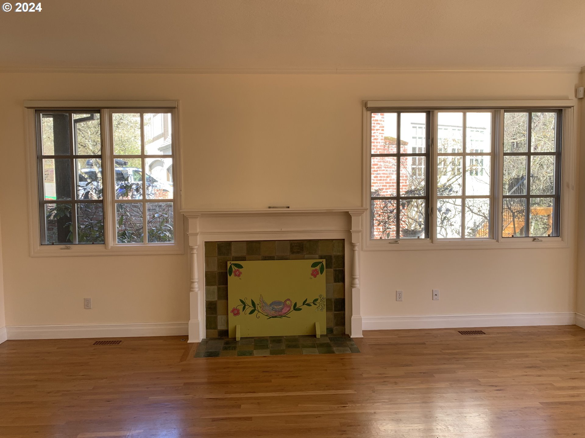 9916 Northwest Abbey Road Portland, OR 97229 - Photo 12 of 48 a view of an empty room with a window and wooden floor