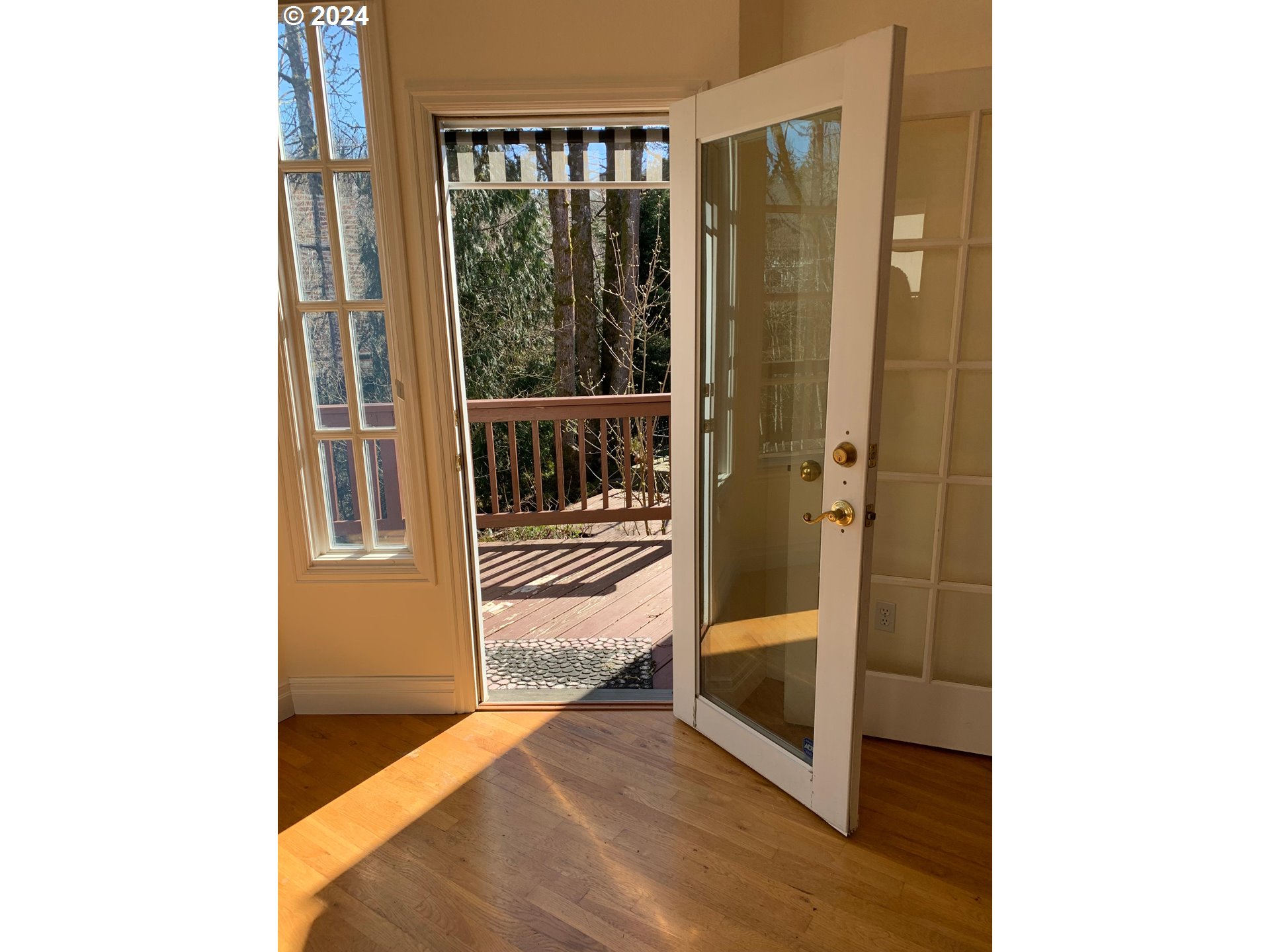 9916 Northwest Abbey Road Portland, OR 97229 - Photo 15 of 48 a view of a hallway with wooden floor and a living room