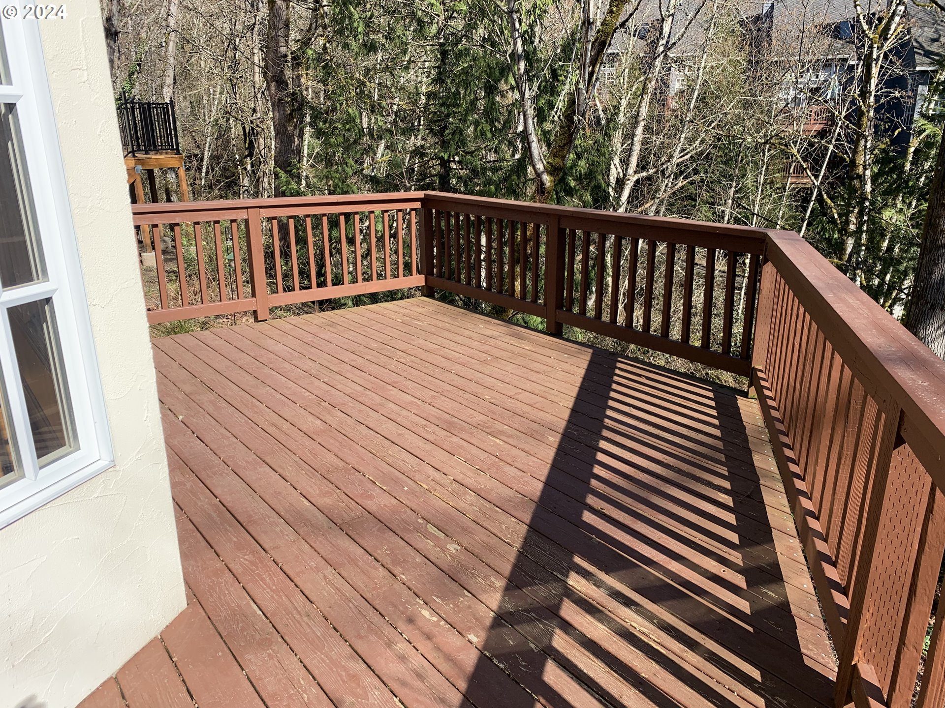 9916 Northwest Abbey Road Portland, OR 97229 - Photo 16 of 48 a balcony with wooden floor