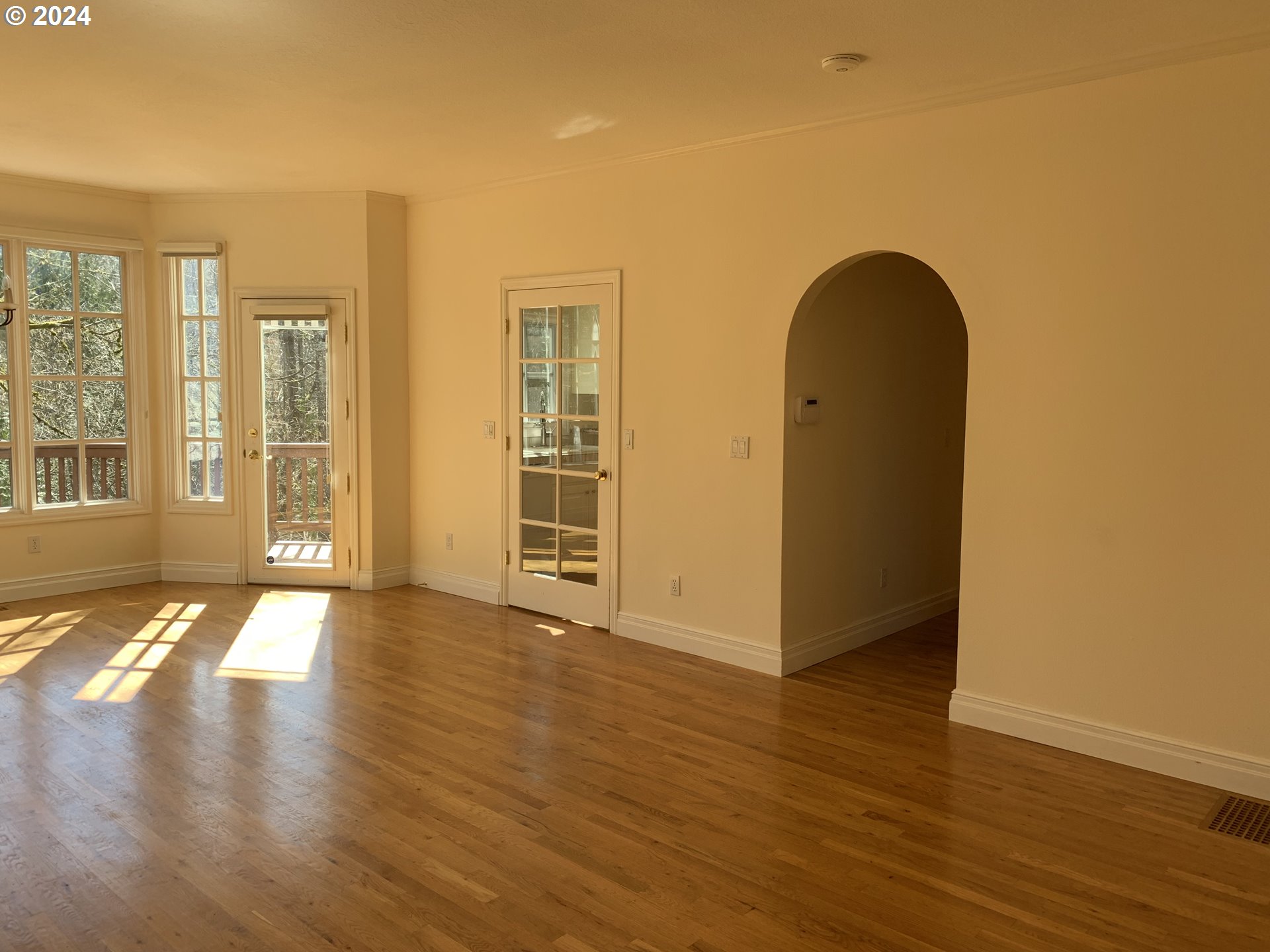 9916 Northwest Abbey Road Portland, OR 97229 - Photo 17 of 48 a view of an empty room with wooden floor and a window
