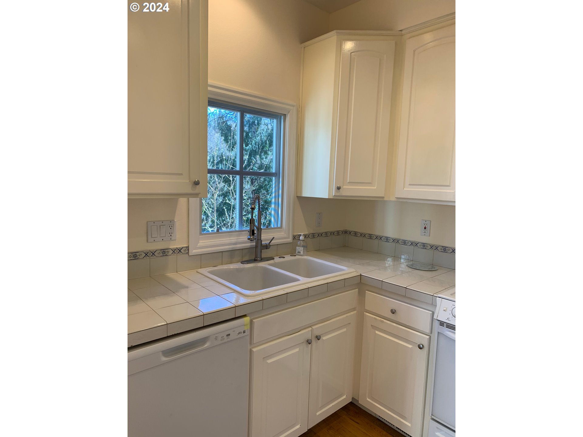 9916 Northwest Abbey Road Portland, OR 97229 - Photo 21 of 48 a kitchen with a sink and cabinets