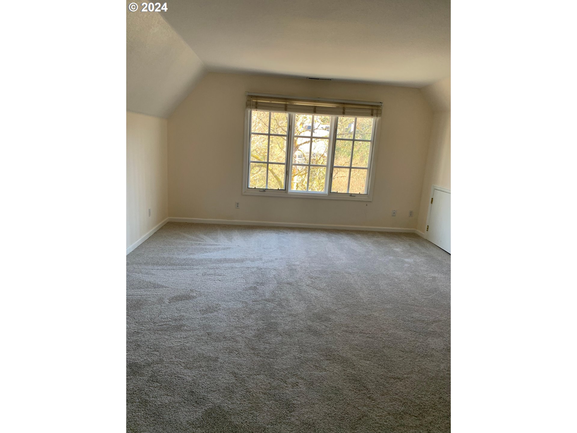 9916 Northwest Abbey Road Portland, OR 97229 - Photo 28 of 48 a view of an empty room with a window