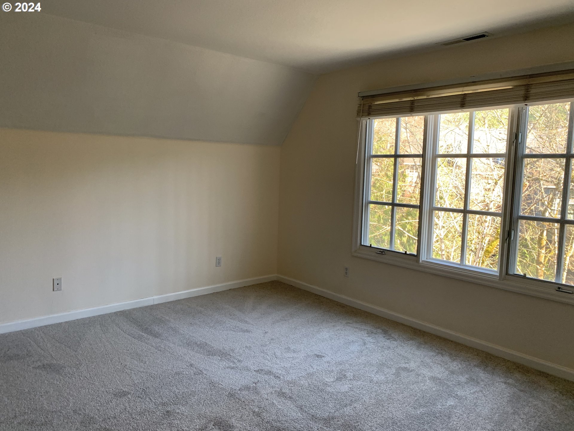 9916 Northwest Abbey Road Portland, OR 97229 - Photo 29 of 48 an empty room with a window