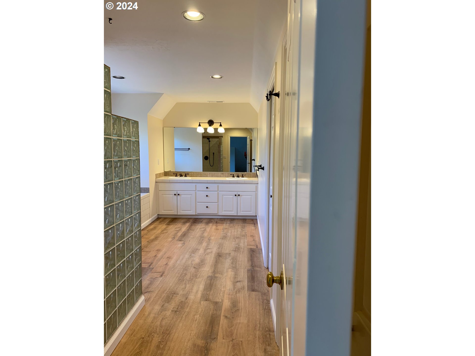 9916 Northwest Abbey Road Portland, OR 97229 - Photo 33 of 48 a view of a bathroom with a sink and mirror