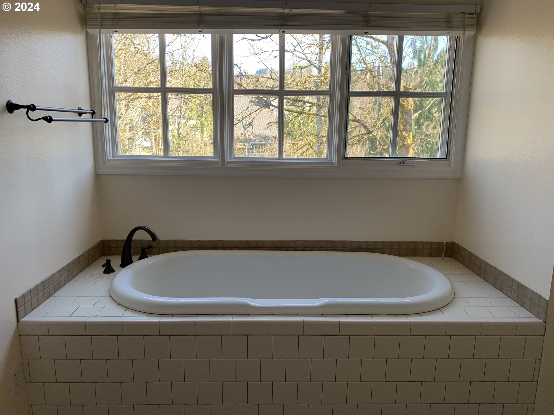 9916 Northwest Abbey Road Portland, OR 97229 - Photo 35 of 48 a bath tub sitting in a bathroom next to a window