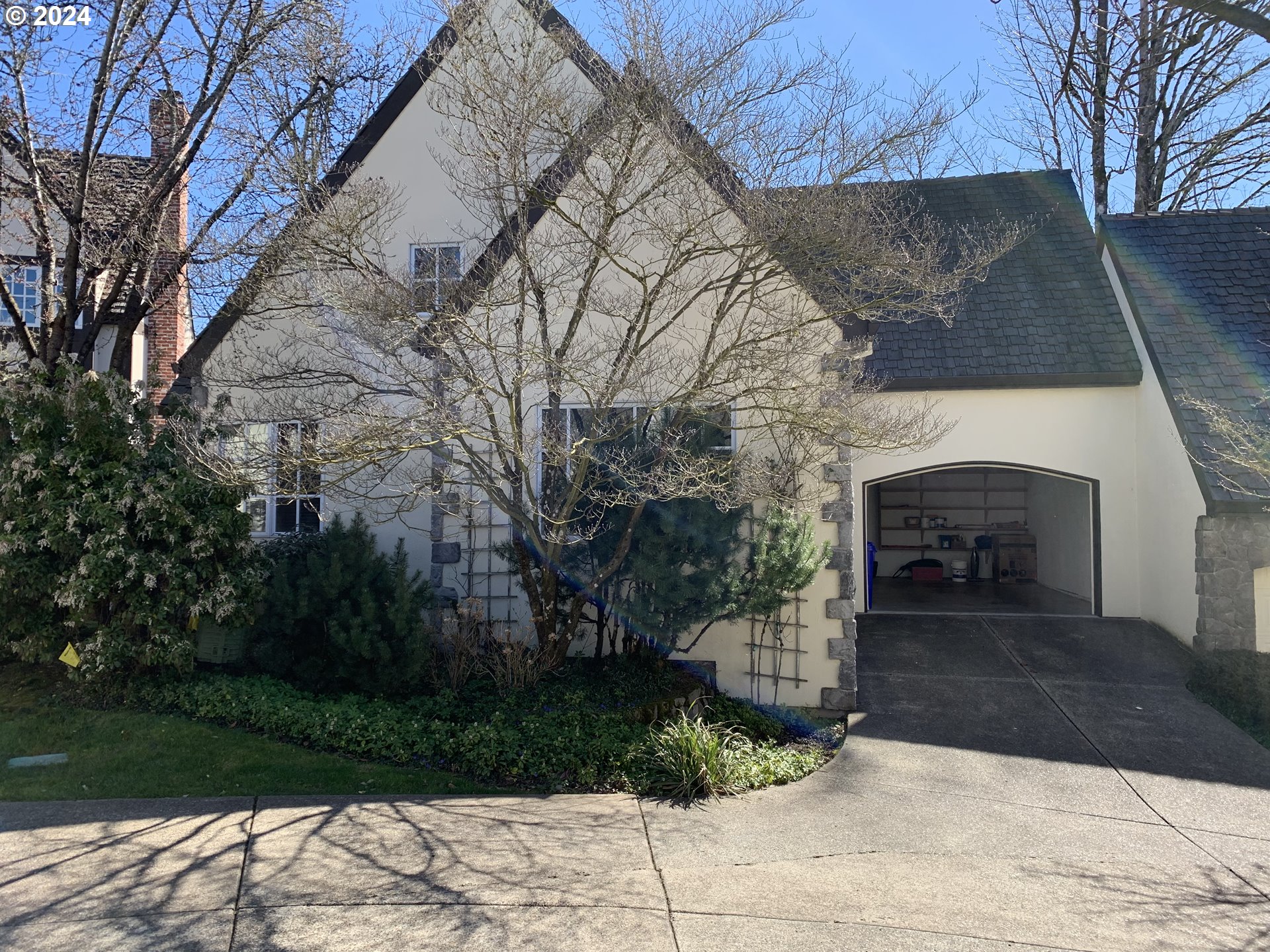 9916 Northwest Abbey Road Portland, OR 97229 - Photo 42 of 48 a front view of a house with a yard and a garden