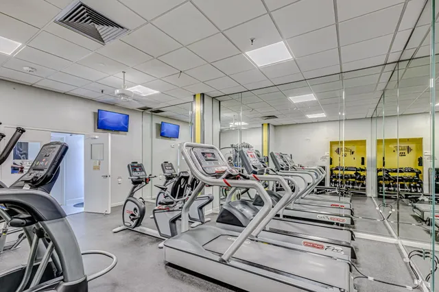 a bathroom with a granite countertop shower sink vanity mirror and toilet