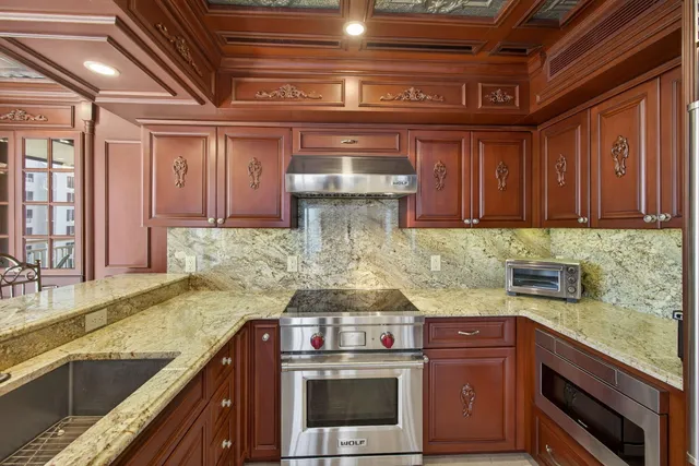 a bathroom with a granite countertop sink a mirror and a shower