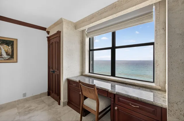 a kitchen with granite countertop a sink a counter space and stainless steel appliances