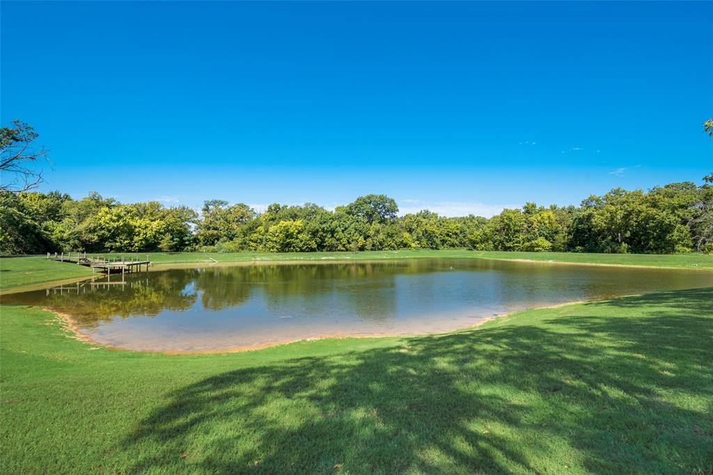 3325 Creek Road Keller, TX 76248 - Photo 25 of 28 a view of a lake with houses in the background