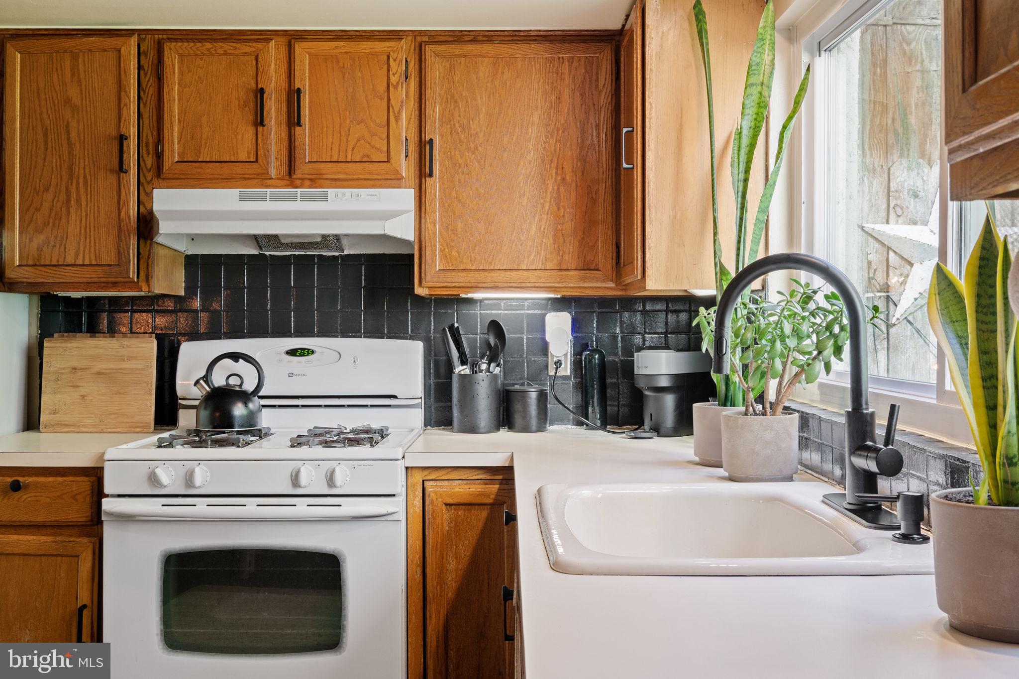 142 Carpenter Street Philadelphia, PA 19147 - Photo 23 of 49 a kitchen with a stove and a white refrigerator