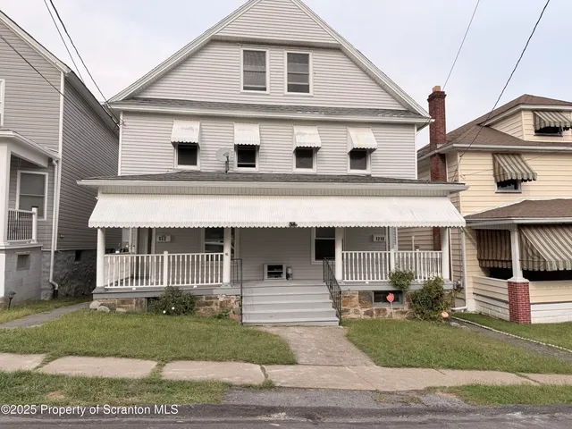 a front view of a house with a garden and garage