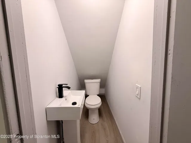 a white toilet sitting next to a white sink