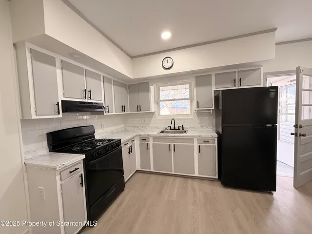 a kitchen with a refrigerator stove and sink