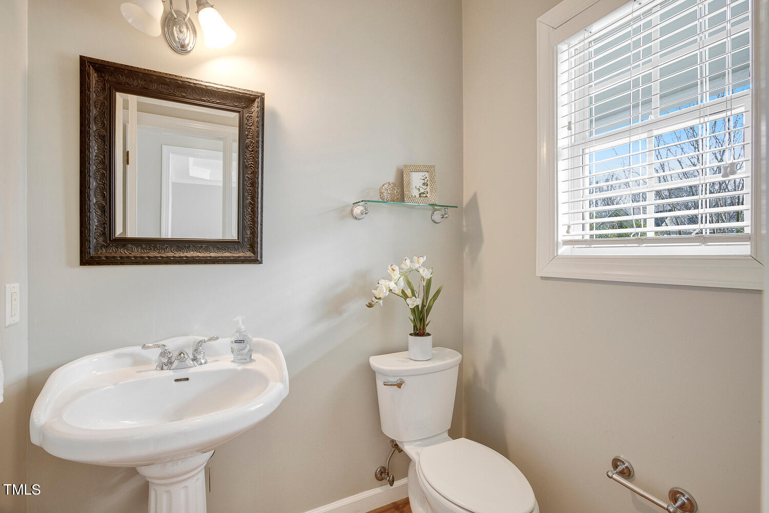 6324 Nowell Pointe Drive Raleigh, NC 27607 - Photo 22 of 50 a bathroom with a toilet sink and mirror