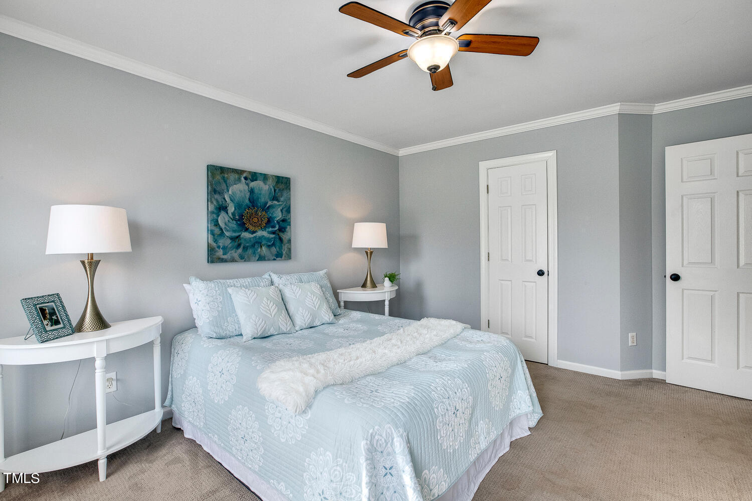 6324 Nowell Pointe Drive Raleigh, NC 27607 - Photo 24 of 50 a bedroom with a bed and a chandelier
