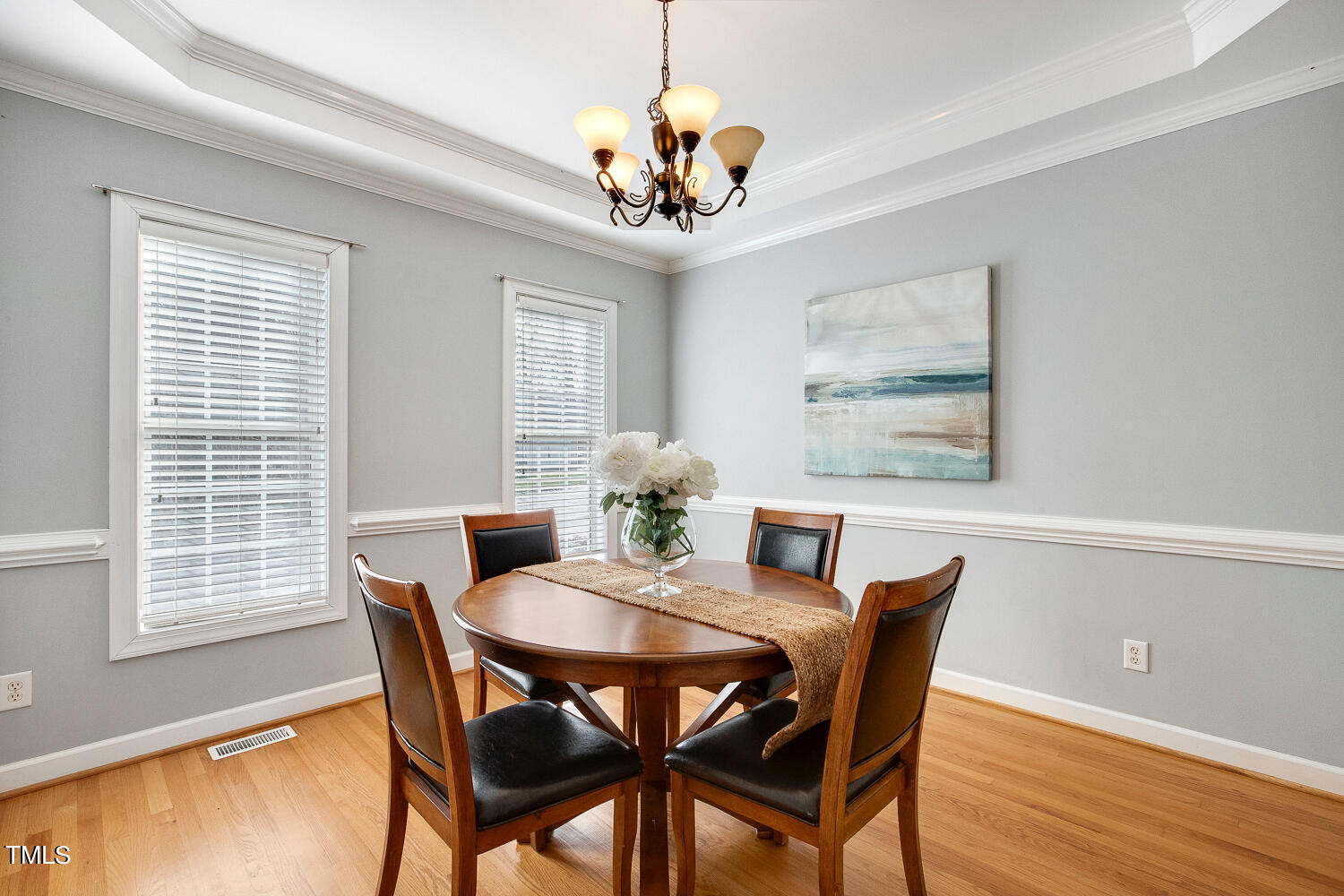 6324 Nowell Pointe Drive Raleigh, NC 27607 - Photo 7 of 50 a dining room with furniture a chandelier and window