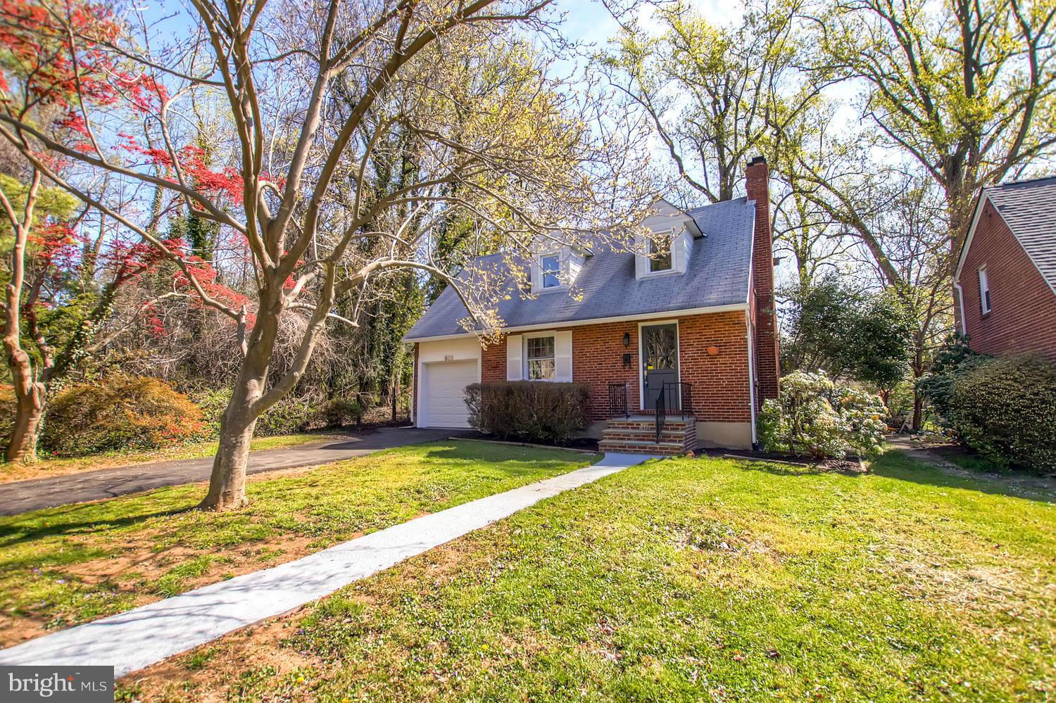 a view of a house with a yard and trees