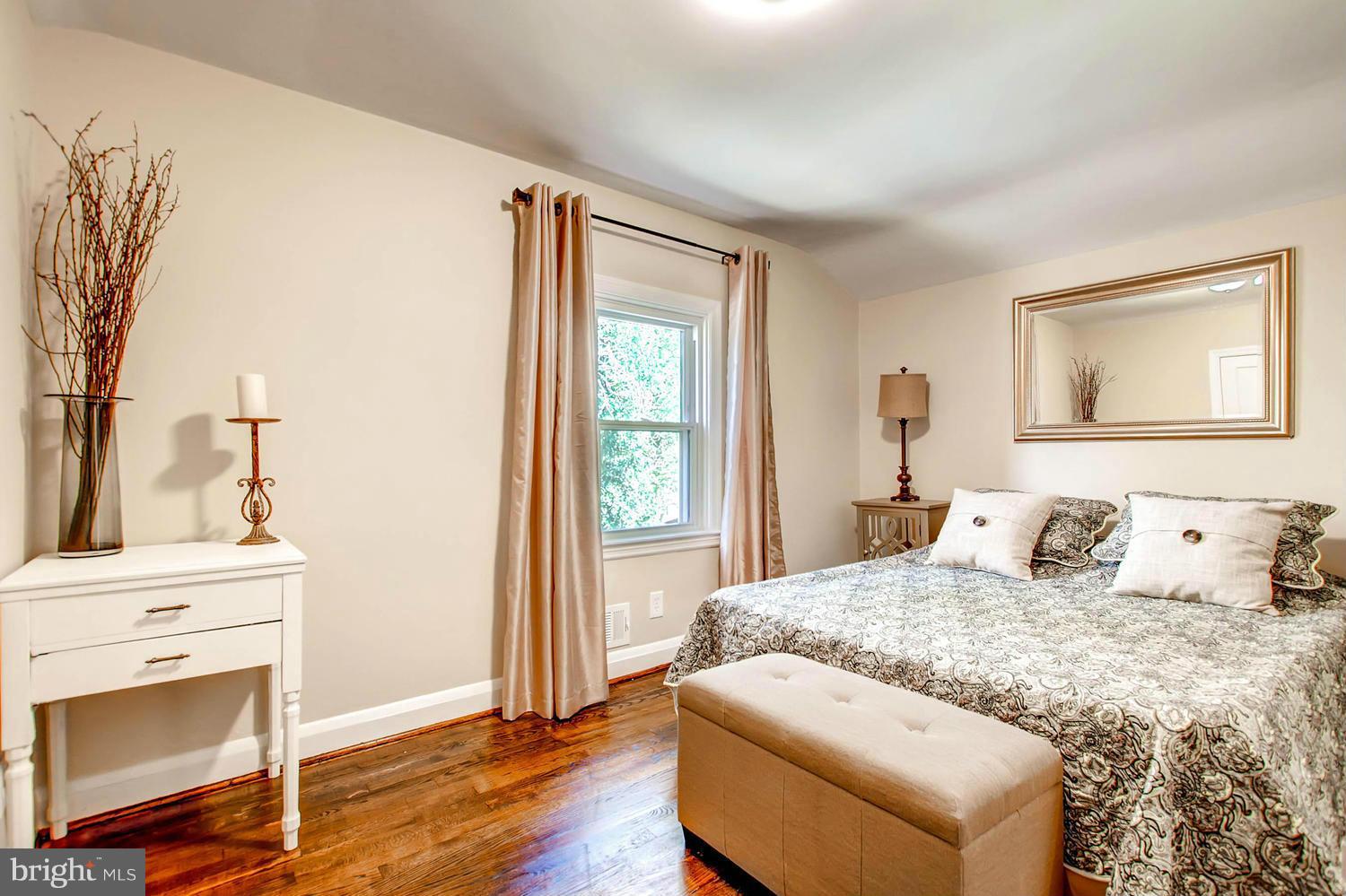 609 Cylburn Road Baltimore, MD 21208 - Photo 14 of 30 a bedroom with a bed and a fireplace