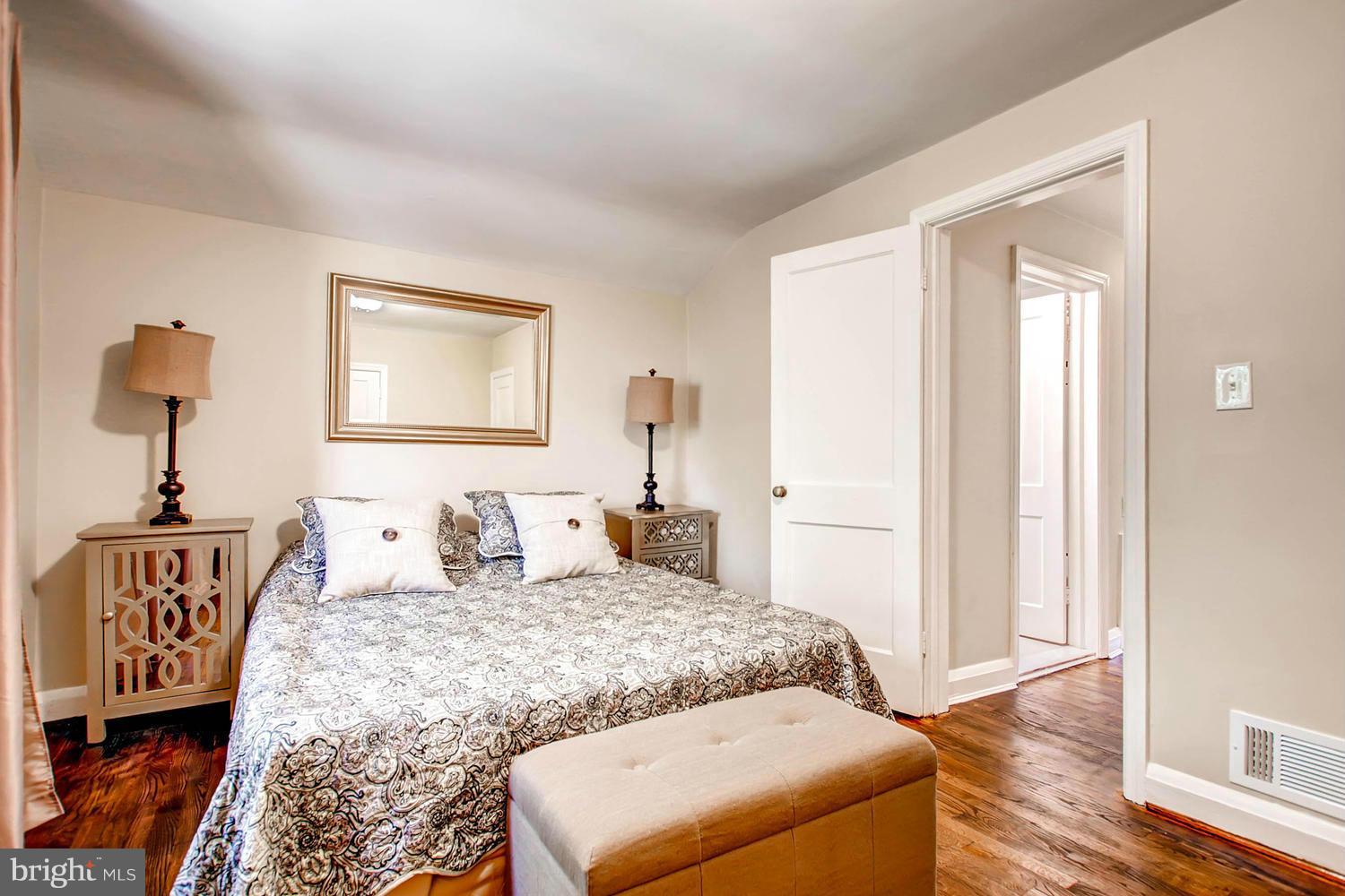 609 Cylburn Road Baltimore, MD 21208 - Photo 15 of 30 a bedroom with a bed and a table in it